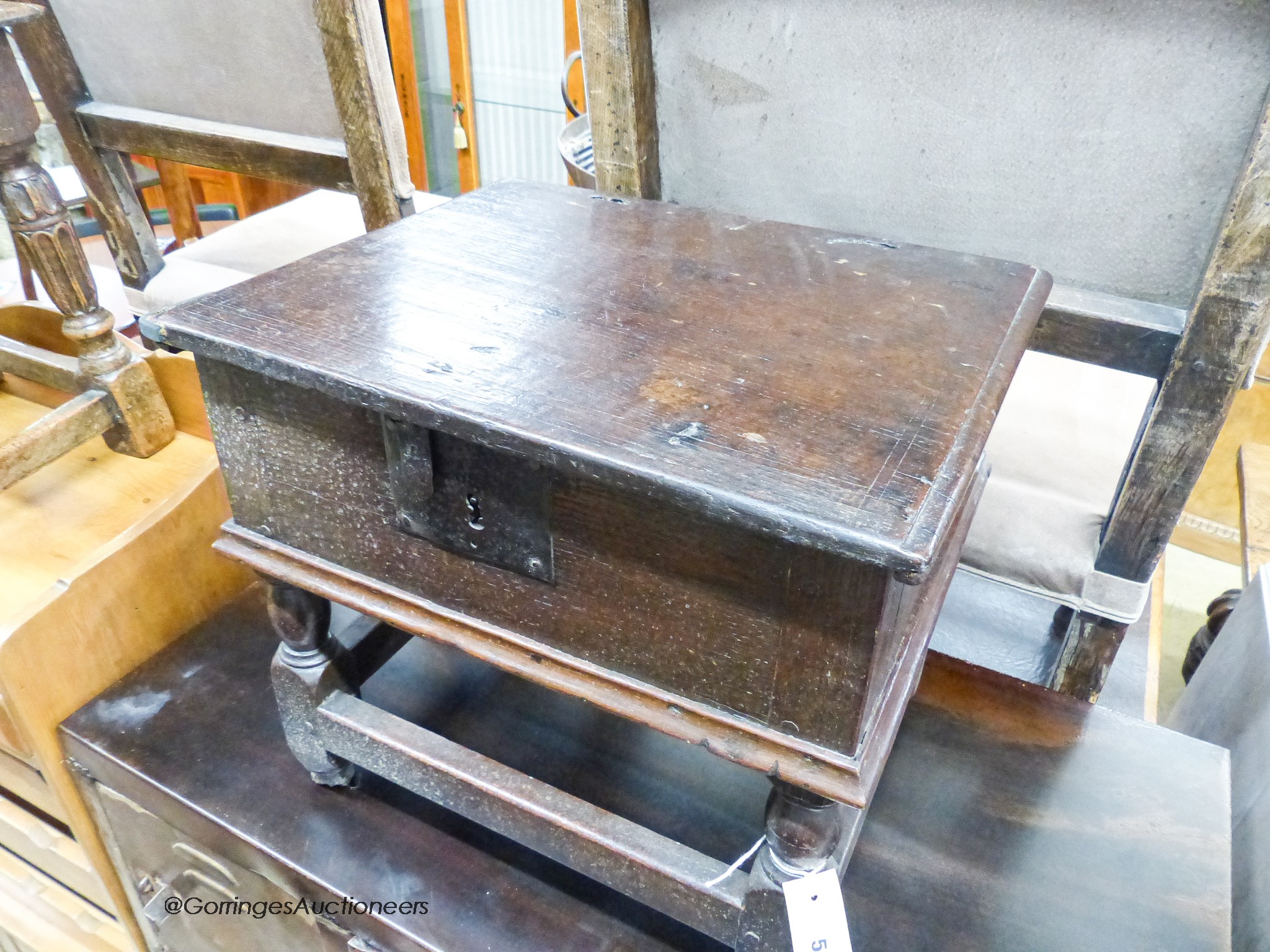 A 17th century oak box stool with hinged rectangular seat, width 46cm, depth 38cm, height 42cm